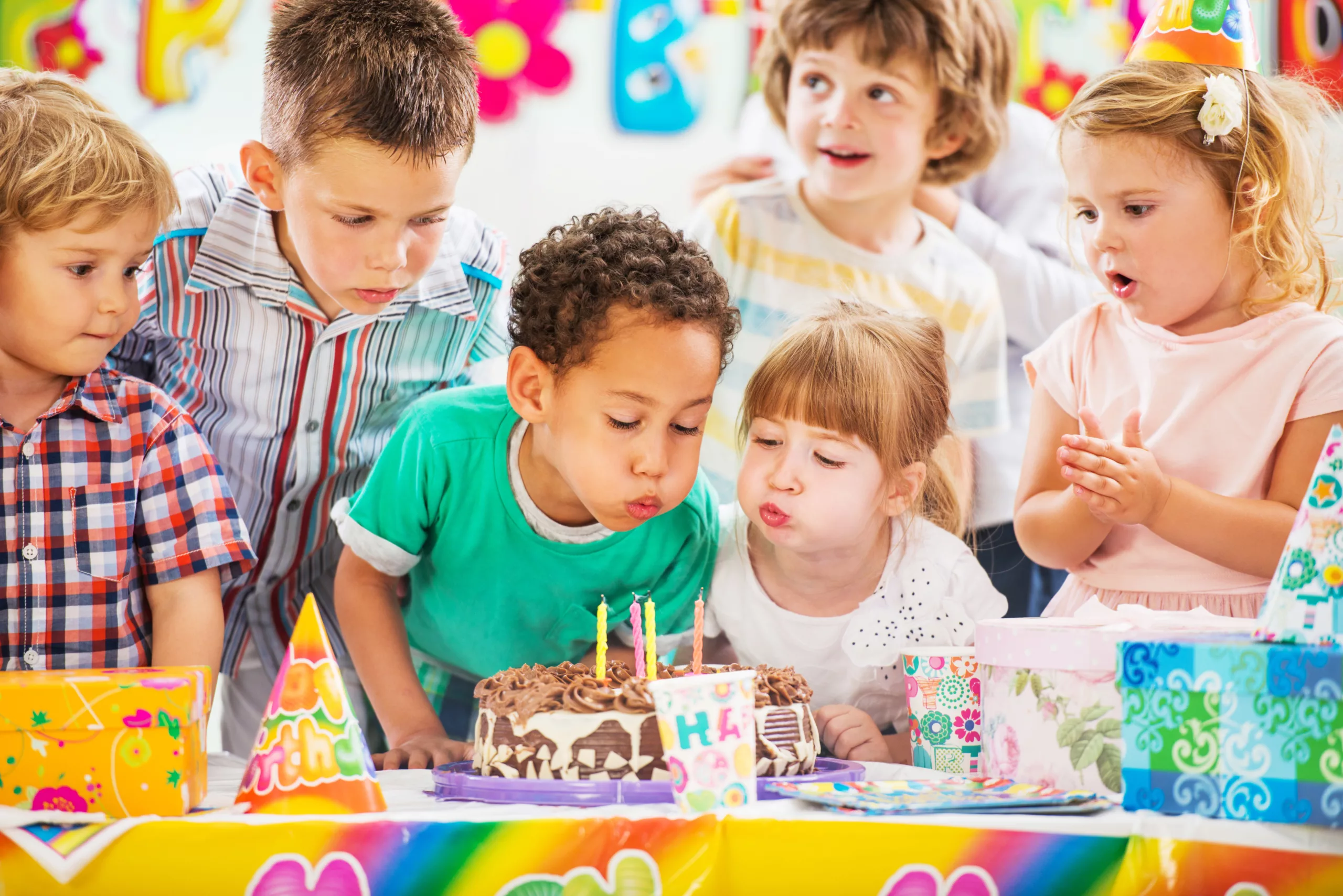Children blowing birthday candles. Children on a birthday party blowing birthday candles.