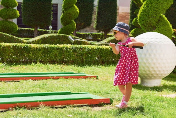 Little girl play with golf